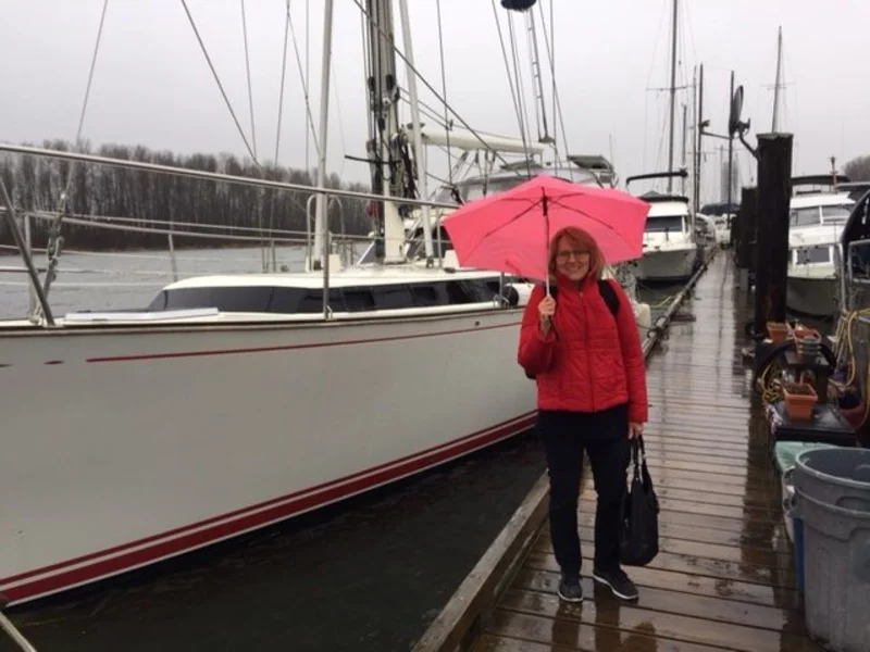 Grace with Umbrella outside sailboat on dock